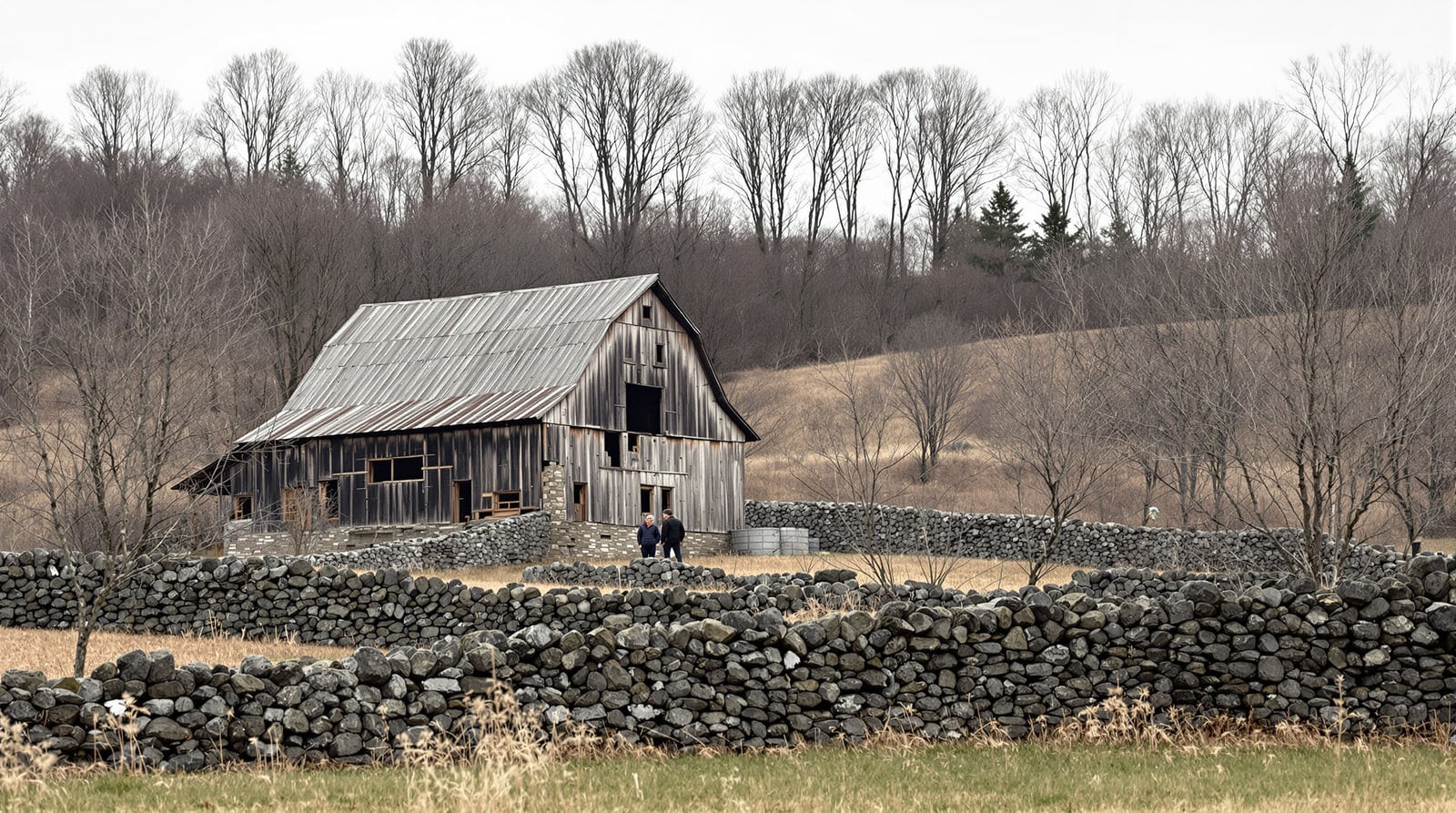 A nineteenth-century Vermont hill farm in early spring with a weathered barn and dry stone walls running up a pasture